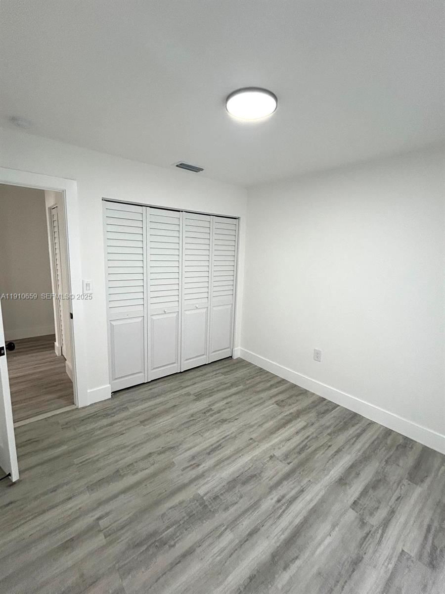 14211 Southwest 286th Street Homestead, FL 33033 - Photo 22 of 38 a view of empty room with wooden floor