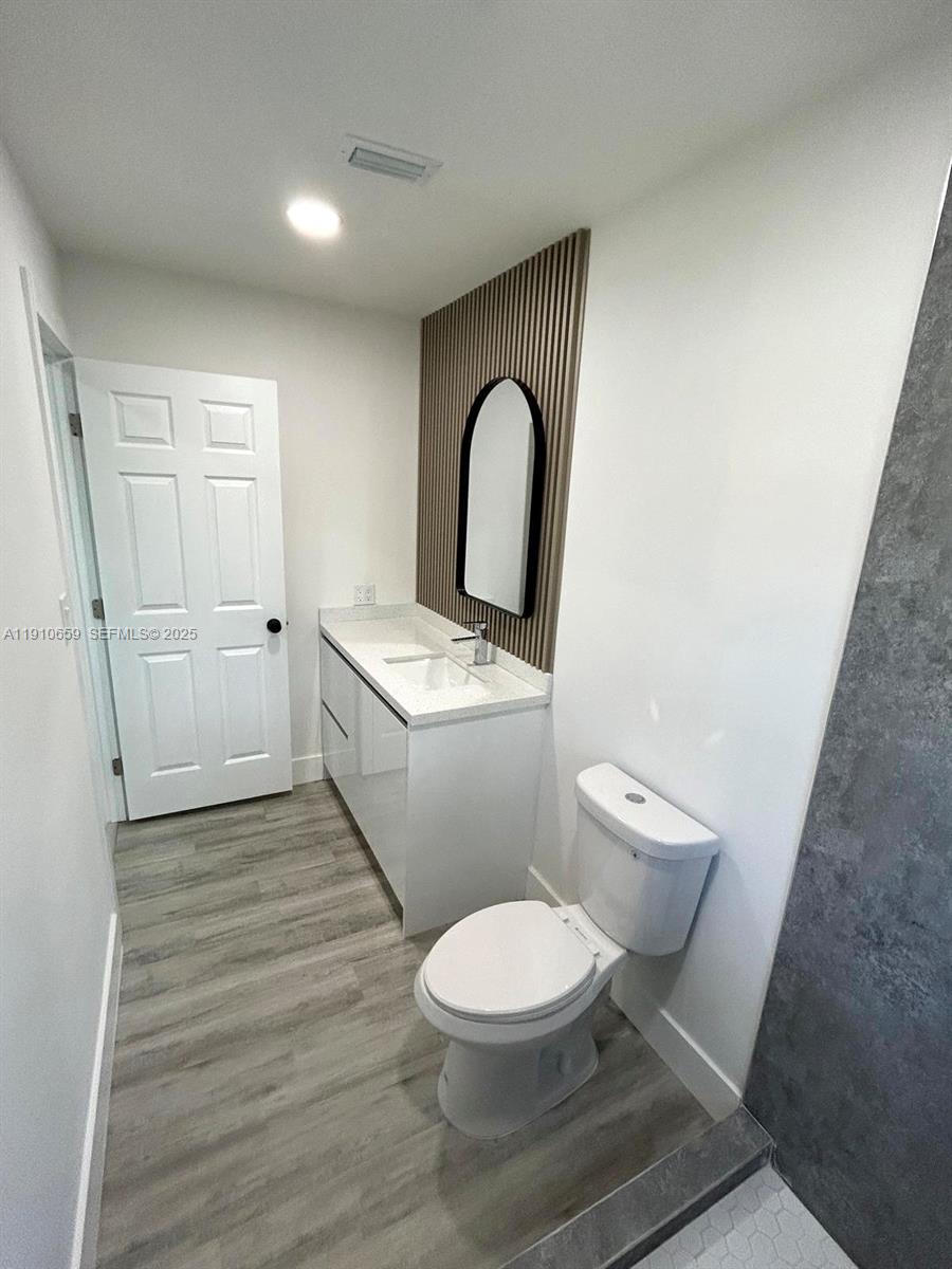 14211 Southwest 286th Street Homestead, FL 33033 - Photo 27 of 38 a white toilet sitting next to a bathroom sink