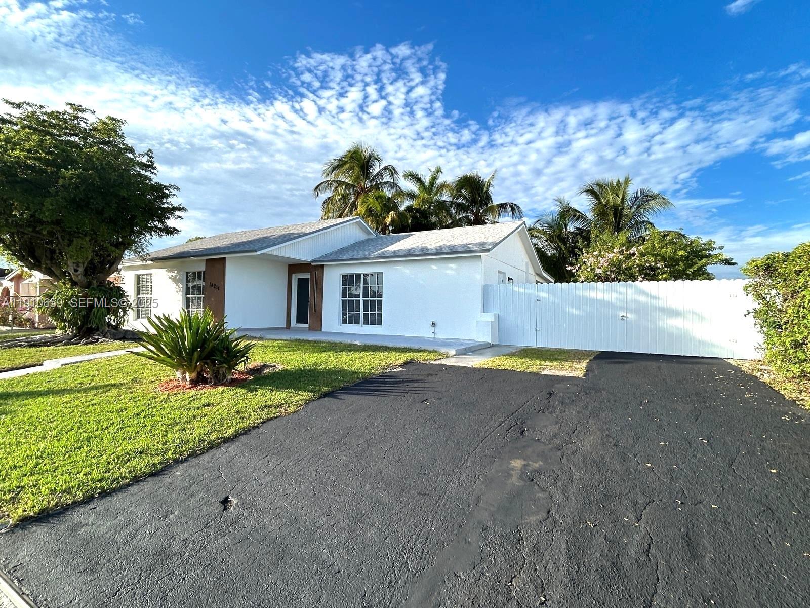 14211 Southwest 286th Street Homestead, FL 33033 - Photo 3 of 38 a house view with a garden space