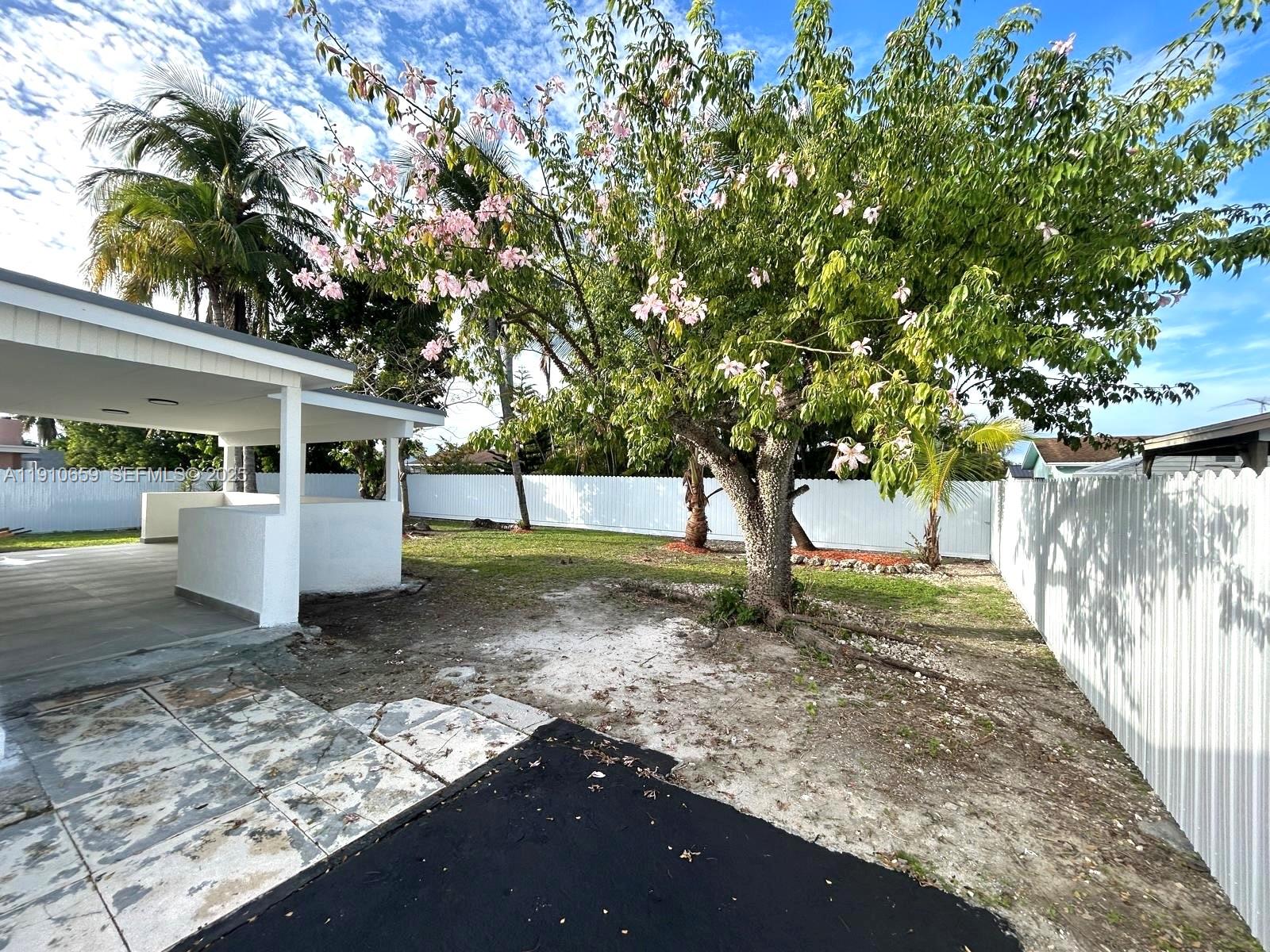 14211 Southwest 286th Street Homestead, FL 33033 - Photo 32 of 38 a view of a yard with plants and a tree