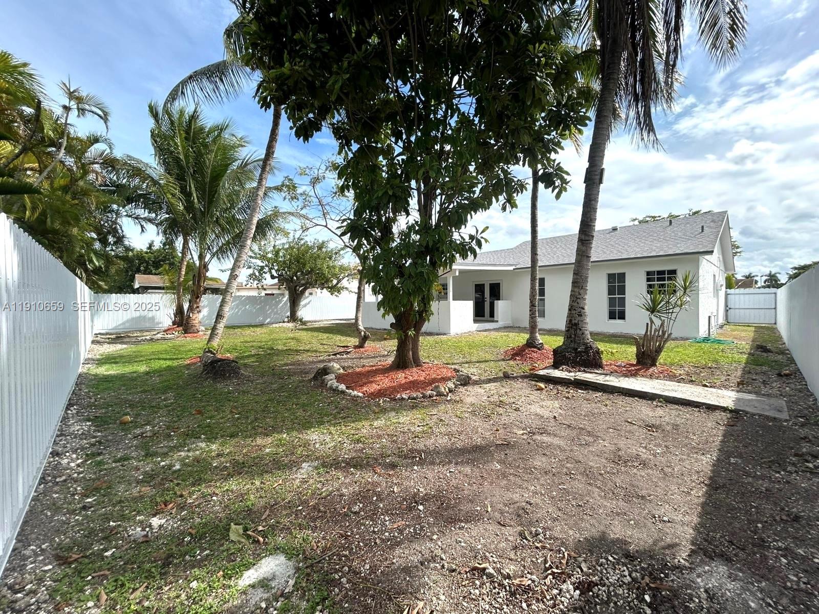14211 Southwest 286th Street Homestead, FL 33033 - Photo 37 of 38 a view of a house with a backyard and a tree