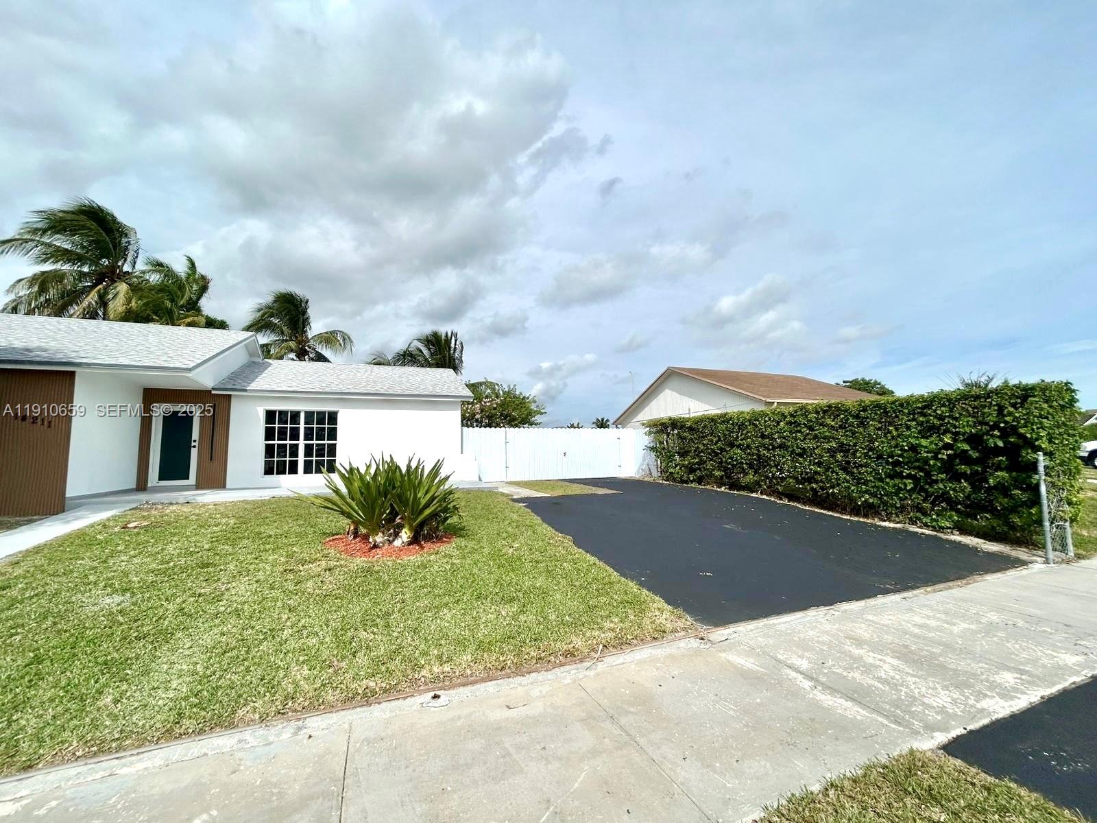 14211 Southwest 286th Street Homestead, FL 33033 - Photo 4 of 38 a view of a house with a yard