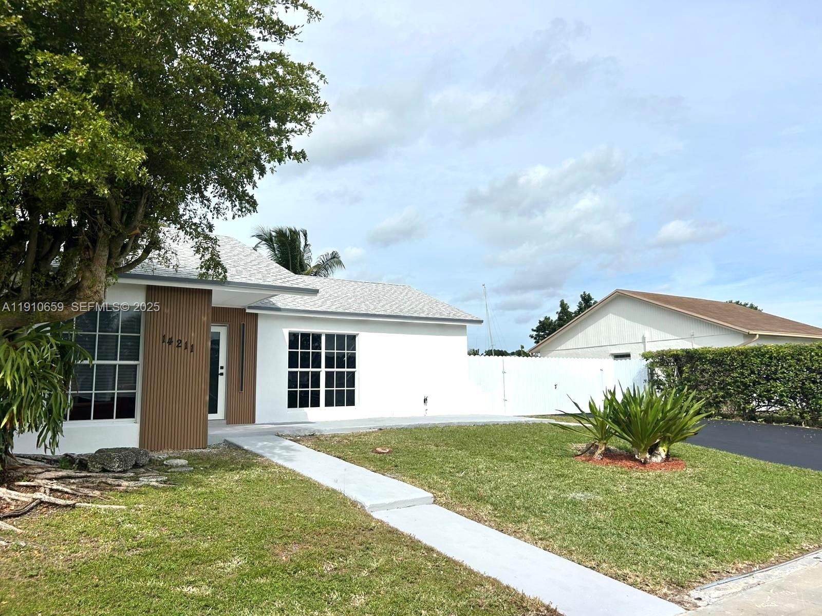 14211 Southwest 286th Street Homestead, FL 33033 - Photo 5 of 38 a view of a house with a yard and potted plants