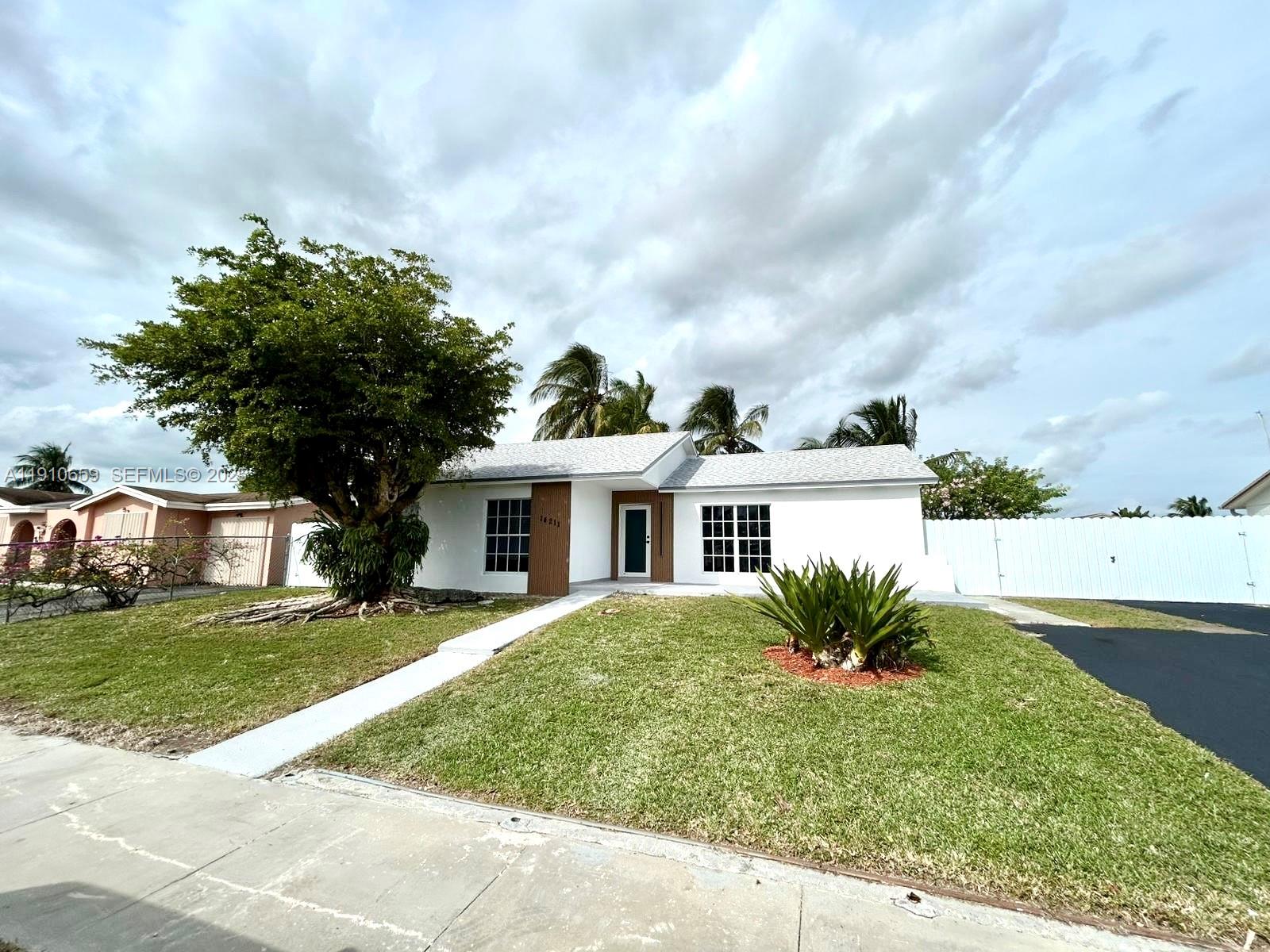 14211 Southwest 286th Street Homestead, FL 33033 - Photo 6 of 38 a front view of a house with a garden