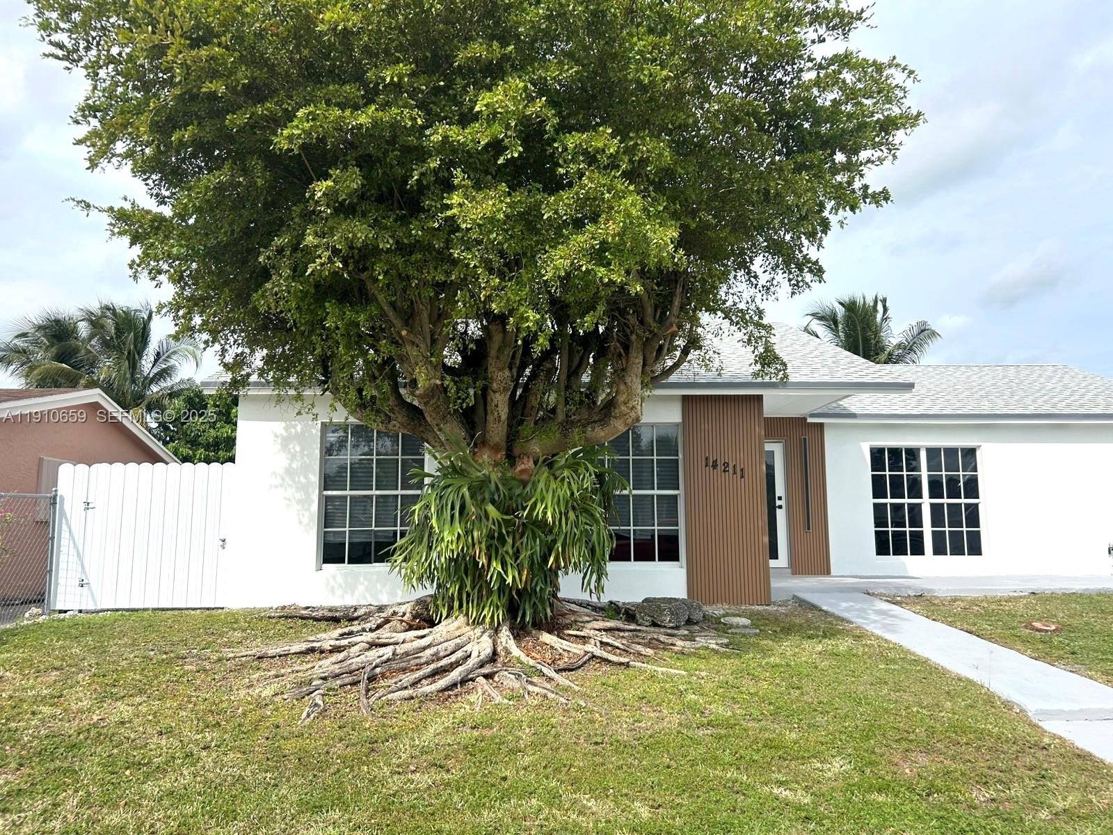 14211 Southwest 286th Street Homestead, FL 33033 - Photo 7 of 38 a view of a house with a tree in front of it
