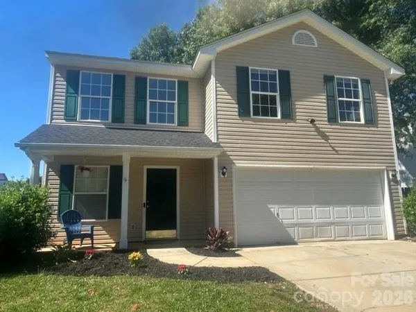 a front view of a house with a yard outdoor seating and garage