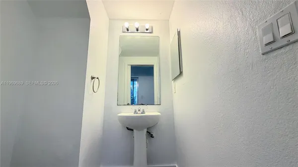 a bathroom with a sink and mirror