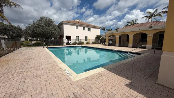 a view of a house with pool table and chairs with wooden floor