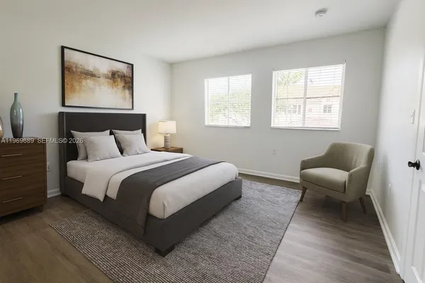 a bedroom with bed and a couch