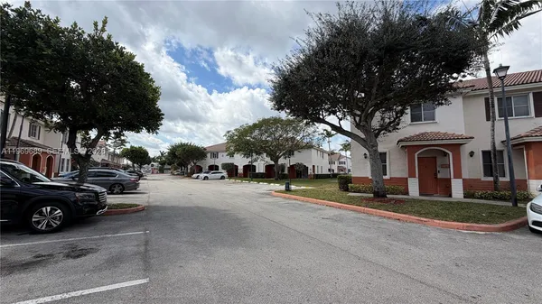 a view of a street with a cars park in front of a house