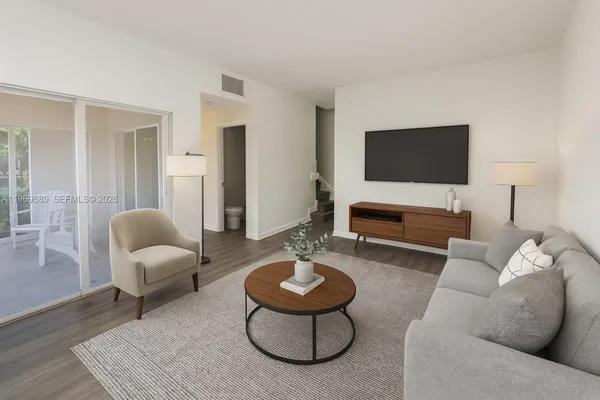 a living room with furniture and a flat screen tv