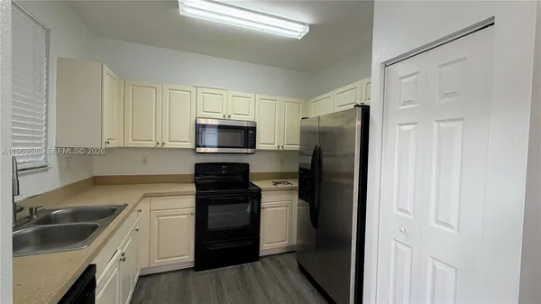 a kitchen with a refrigerator stove and sink