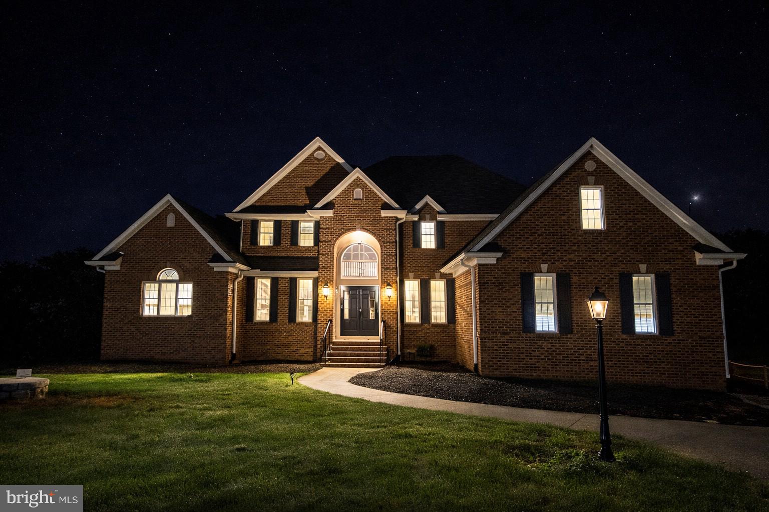 257 Church Point Lane Colonial Beach, VA 22443 - Photo 2 of 25 Elegant brick home illuminated at night.