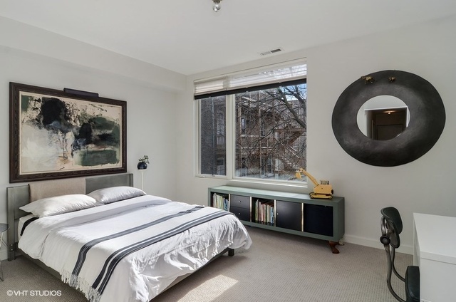 2811 West Shakespeare Avenue Chicago, IL 60647 - Photo 16 of 20 a bedroom with a bed and a large window