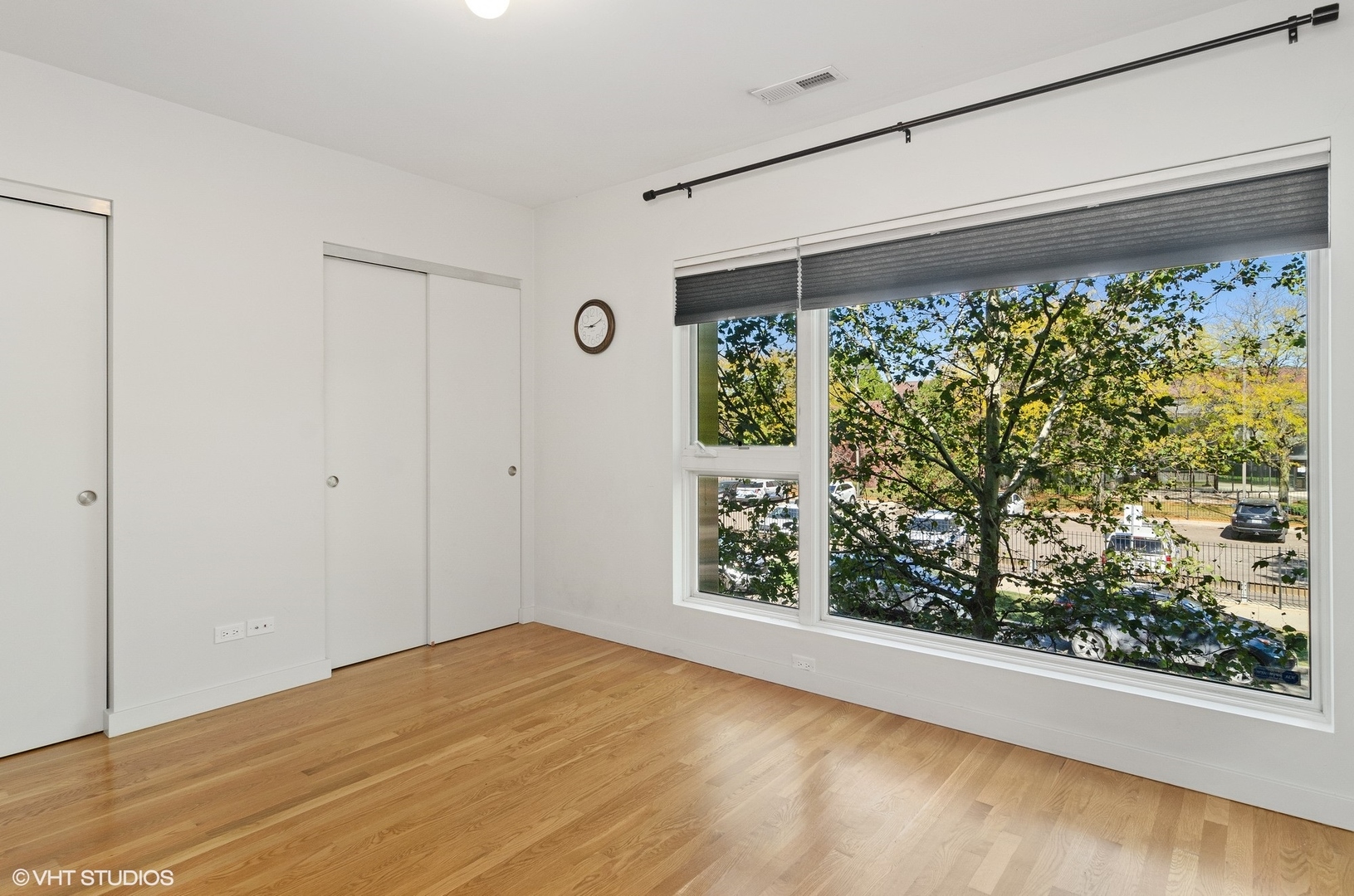 2811 West Shakespeare Avenue Chicago, IL 60647 - Photo 17 of 20 a view of empty room with a window and wooden floor