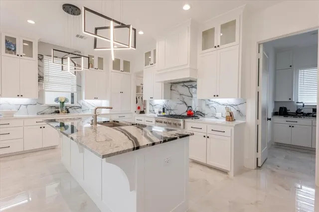 a kitchen with stainless steel appliances granite countertop a sink and cabinets