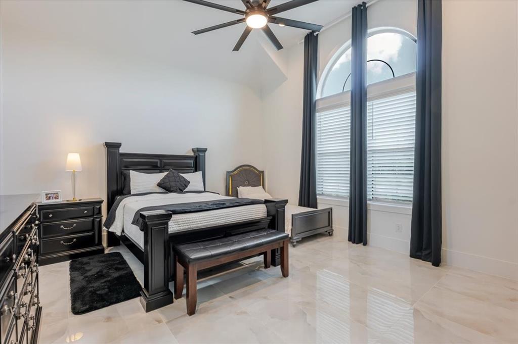 7381 Mesquite Ridge Sanger, TX 76266 - Photo 16 of 40 a bedroom with a bed and a chandelier