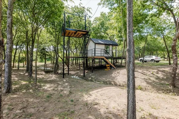 a view of outdoor space with deck and trees
