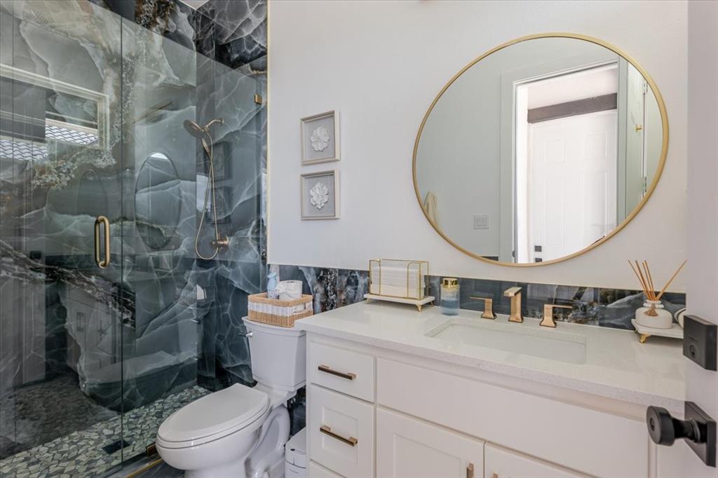 7381 Mesquite Ridge Sanger, TX 76266 - Photo 39 of 40 a bathroom with a sink mirror and toilet