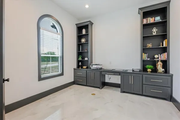 a room with a large window and cabinet