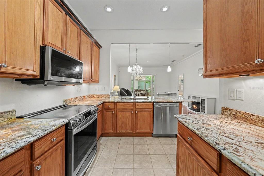 7411 Wimpole Drive New Port Richey, FL 34655 - Photo 2 of 21 a kitchen with a sink stove top oven and cabinets
