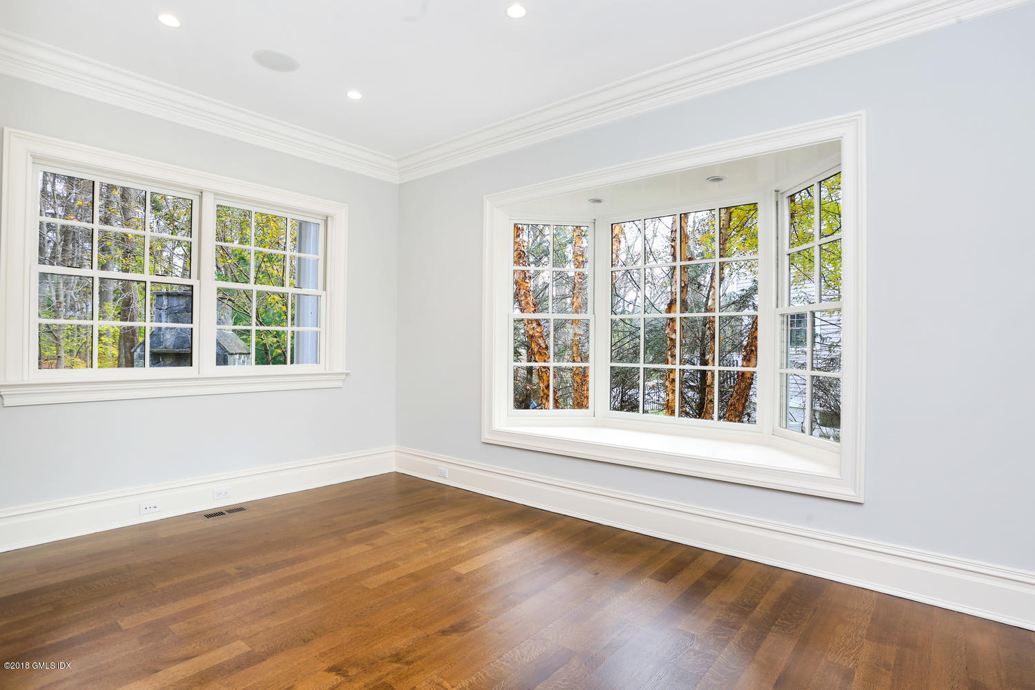 17 Dialstone Lane Riverside, CT 06878 - Photo 22 of 50 a view of an empty room with wooden floor and a window