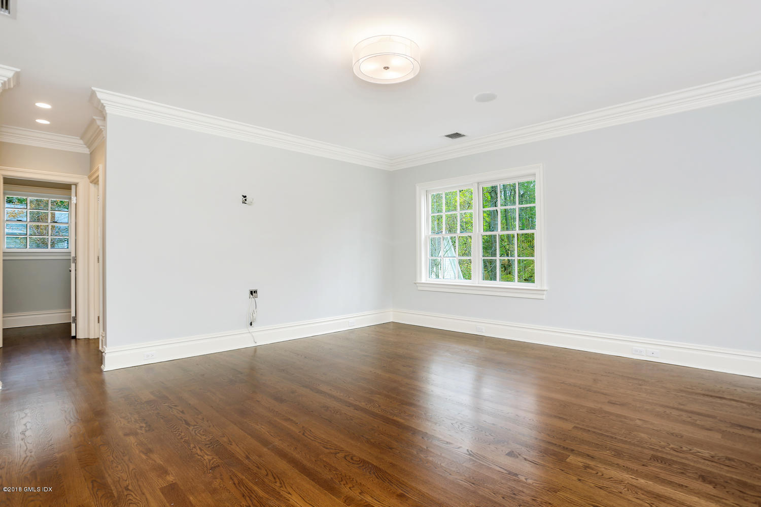 17 Dialstone Lane Riverside, CT 06878 - Photo 24 of 50 an empty room with wooden floor and windows