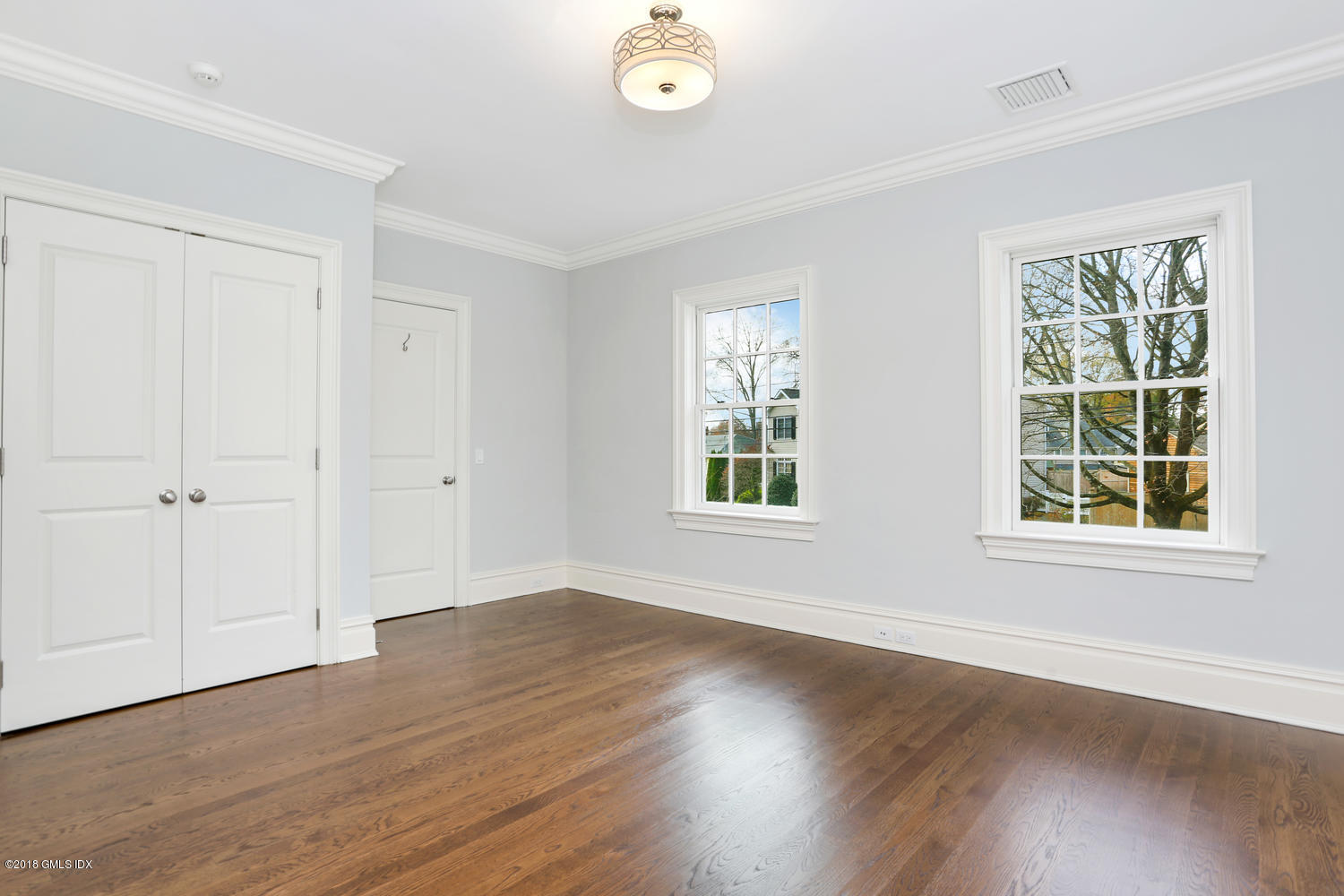 17 Dialstone Lane Riverside, CT 06878 - Photo 28 of 50 an empty room with wooden floor and windows