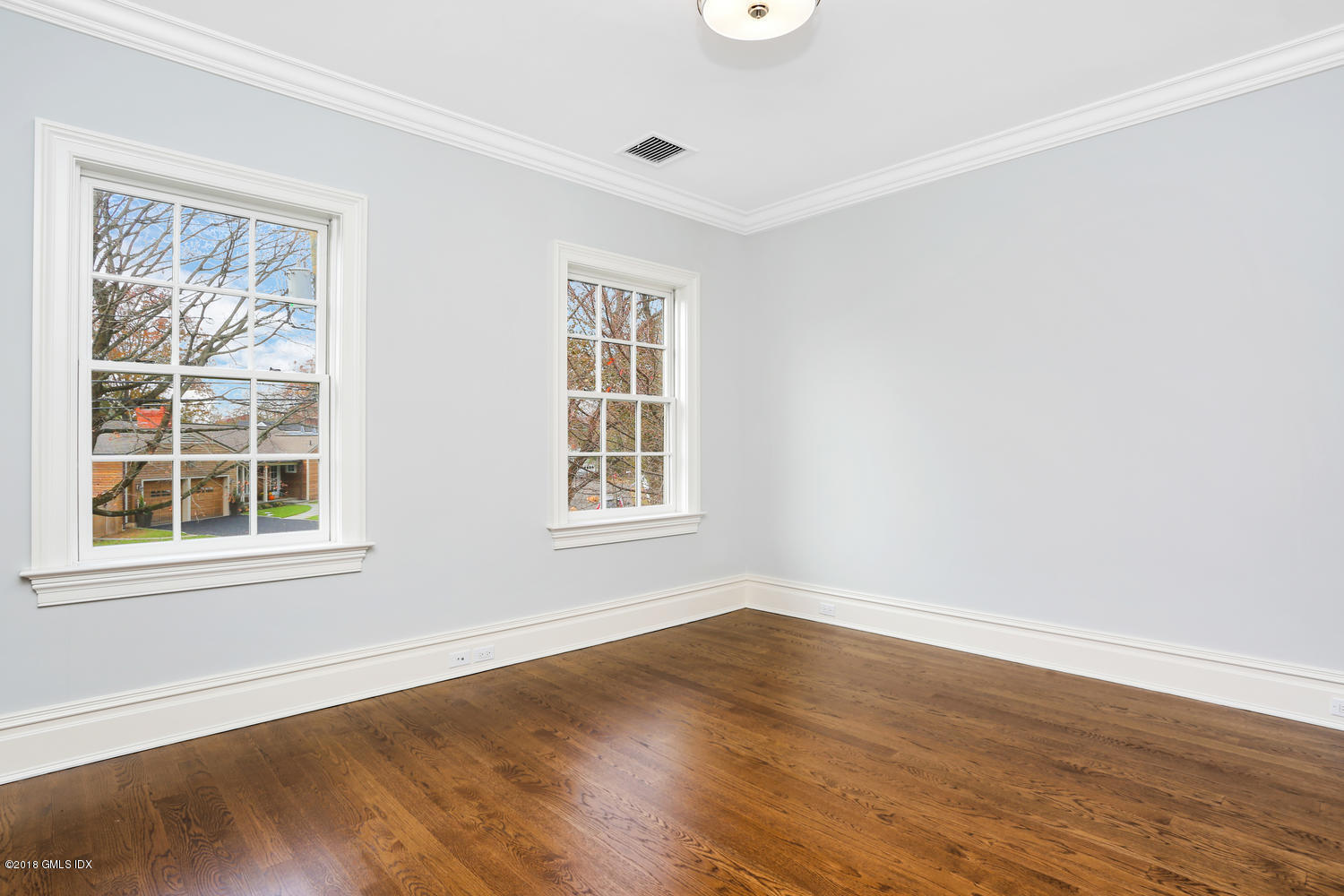17 Dialstone Lane Riverside, CT 06878 - Photo 29 of 50 an empty room with wooden floor and windows