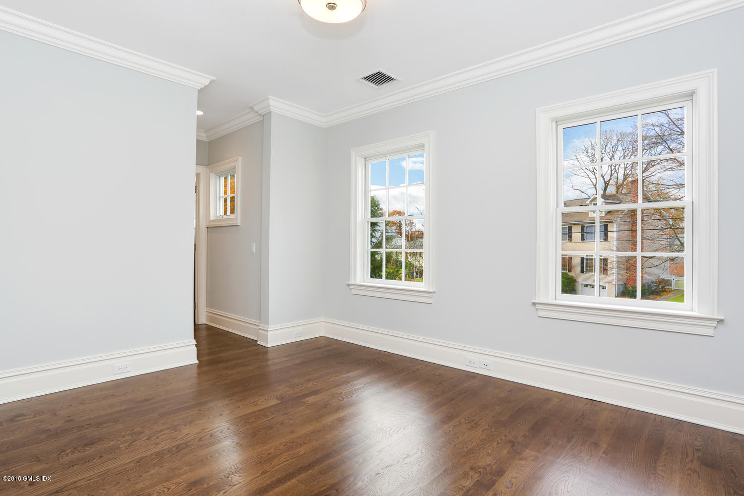 17 Dialstone Lane Riverside, CT 06878 - Photo 30 of 50 an empty room with wooden floor and windows