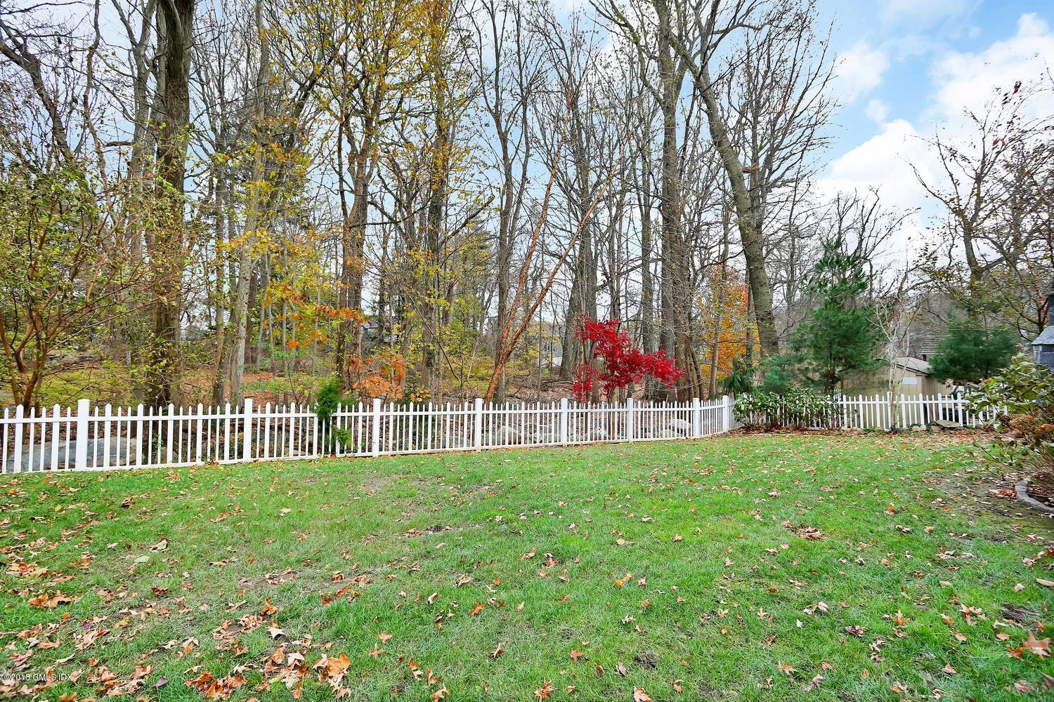 17 Dialstone Lane Riverside, CT 06878 - Photo 36 of 50 a view of a park with large trees and a big yard with wooden fence