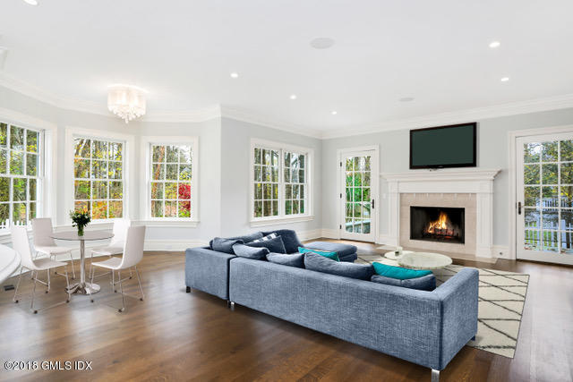 17 Dialstone Lane Riverside, CT 06878 - Photo 7 of 50 a living room with furniture a flat screen tv and a fireplace