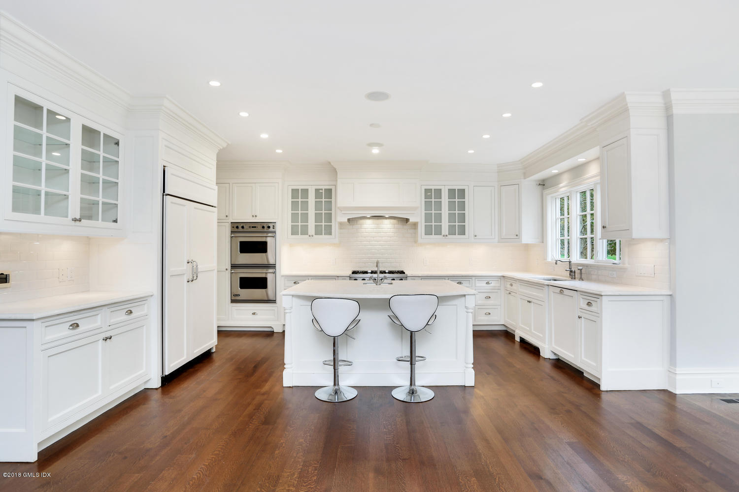 17 Dialstone Lane Riverside, CT 06878 - Photo 10 of 50 a kitchen with white cabinets and center island