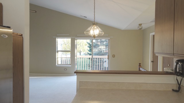 913 Ridgefield Lane Wheeling, IL 60090 - Photo 6 of 23 a living room with a large window and chandelier