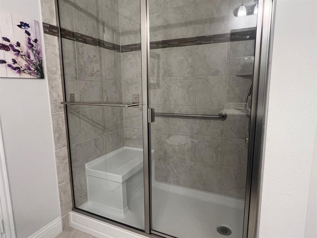 651 Watters Road, Unit 7101 Allen, TX 75013 - Photo 13 of 25 a bathroom with a glass shower door
