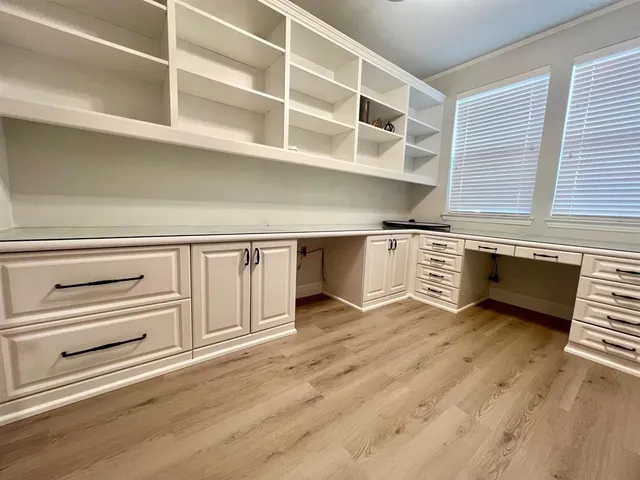 a view of a kitchen with a sink and cabinets