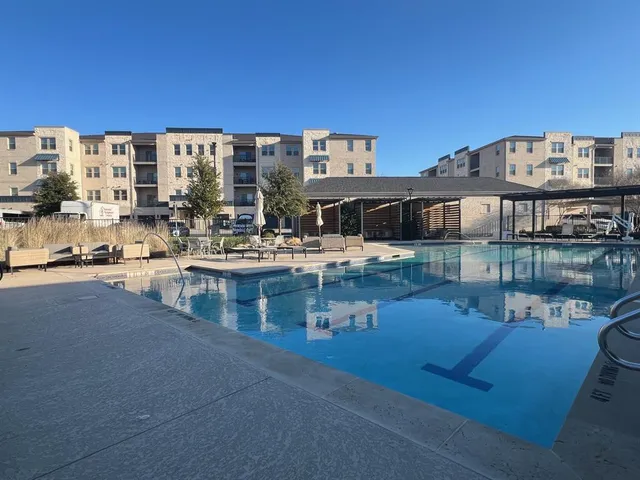 a large building with a table and chairs