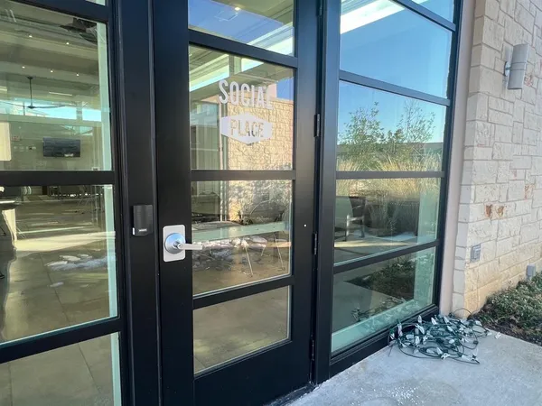 a view of a glass door with a yard from a window