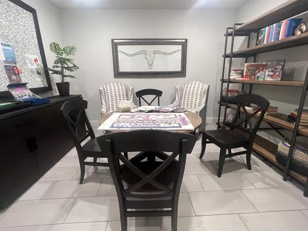 a view of a dining room with furniture and a book shelf