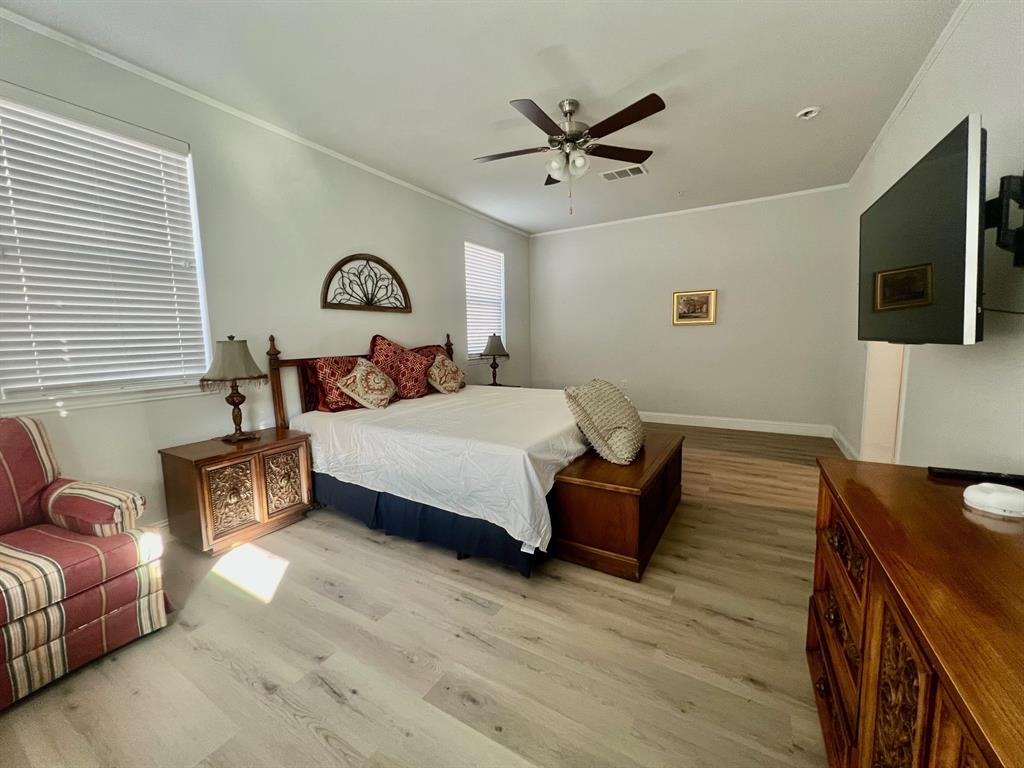 651 Watters Road, Unit 7101 Allen, TX 75013 - Photo 9 of 25 a bedroom with a bed and a television on desk