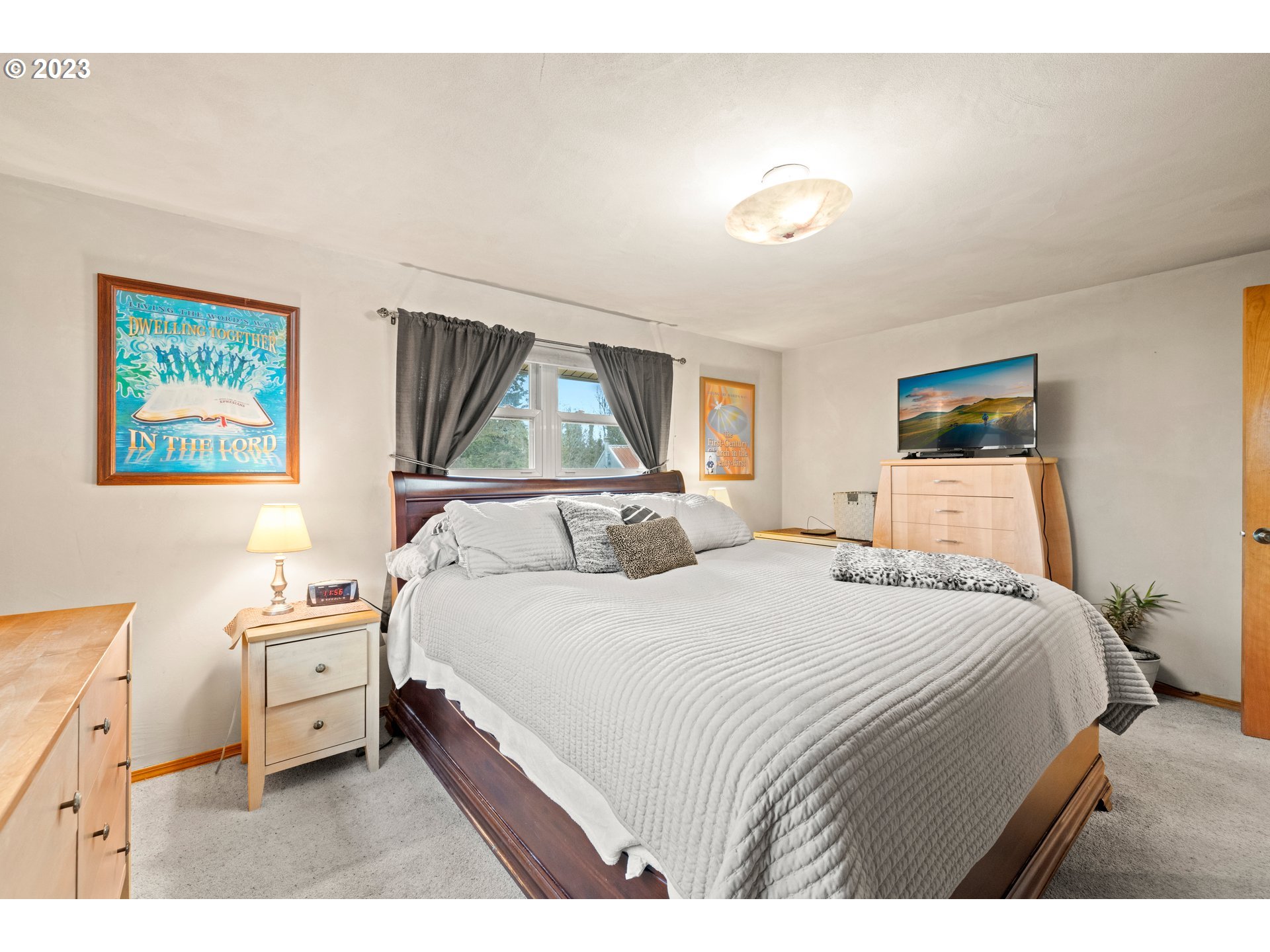 8880 Southwest River Road Hillsboro, OR 97123 - Photo 11 of 25 a bedroom with a bed and a painting on the wall