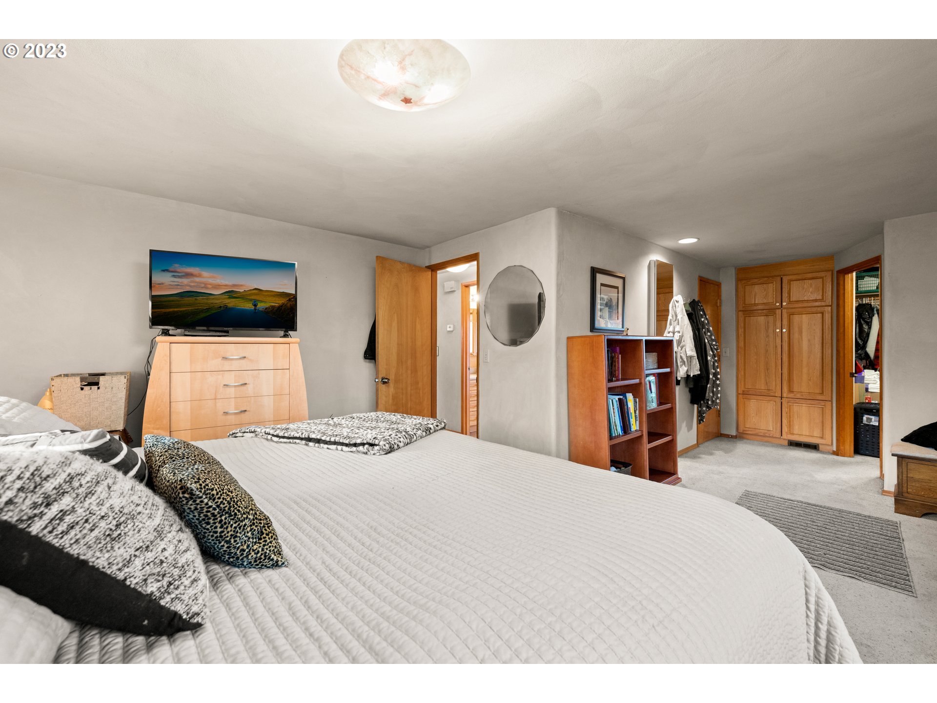 8880 Southwest River Road Hillsboro, OR 97123 - Photo 12 of 25 a bedroom with a bed and dresser