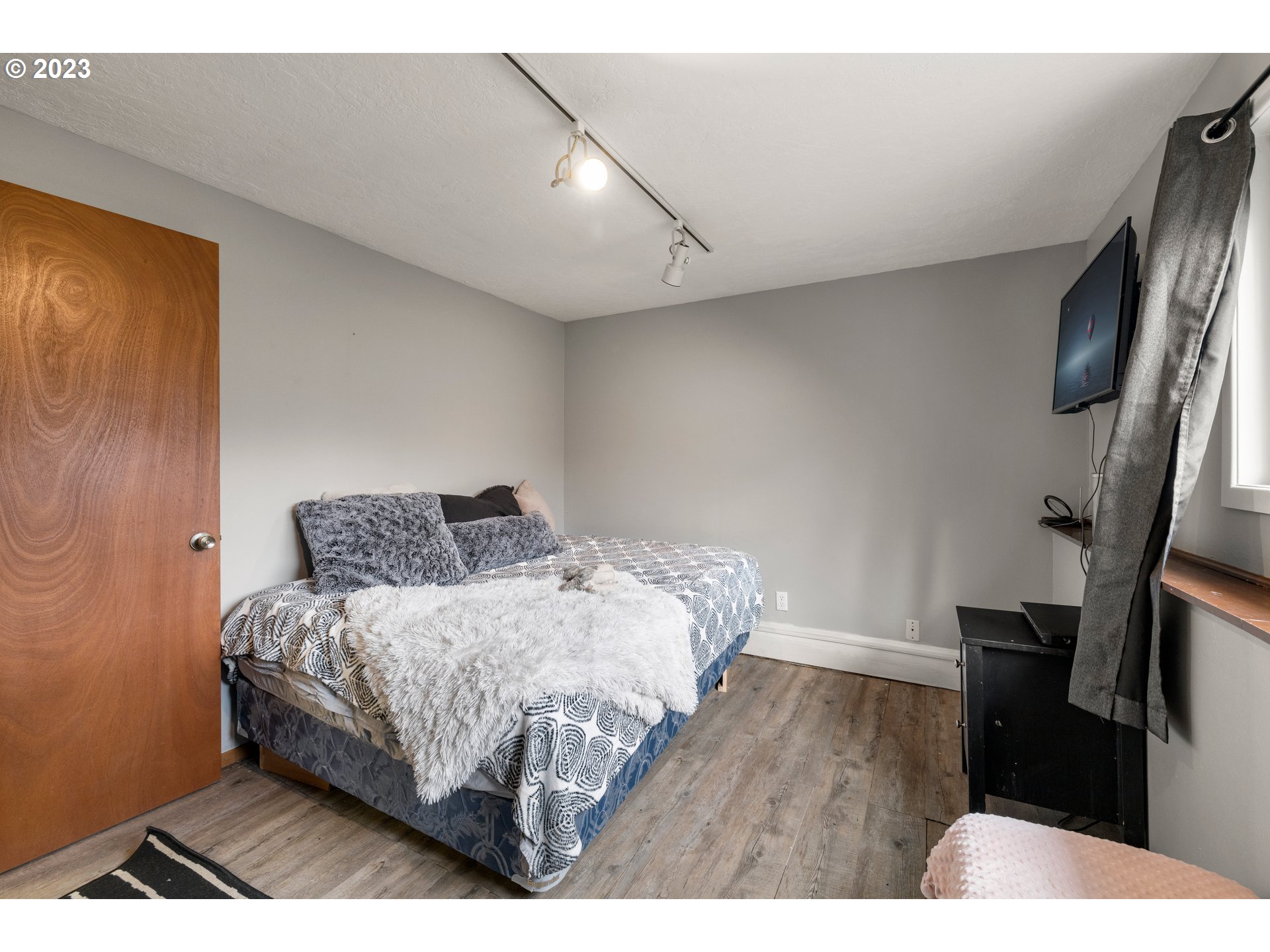 8880 Southwest River Road Hillsboro, OR 97123 - Photo 16 of 25 a bedroom with a bed and wooden floor
