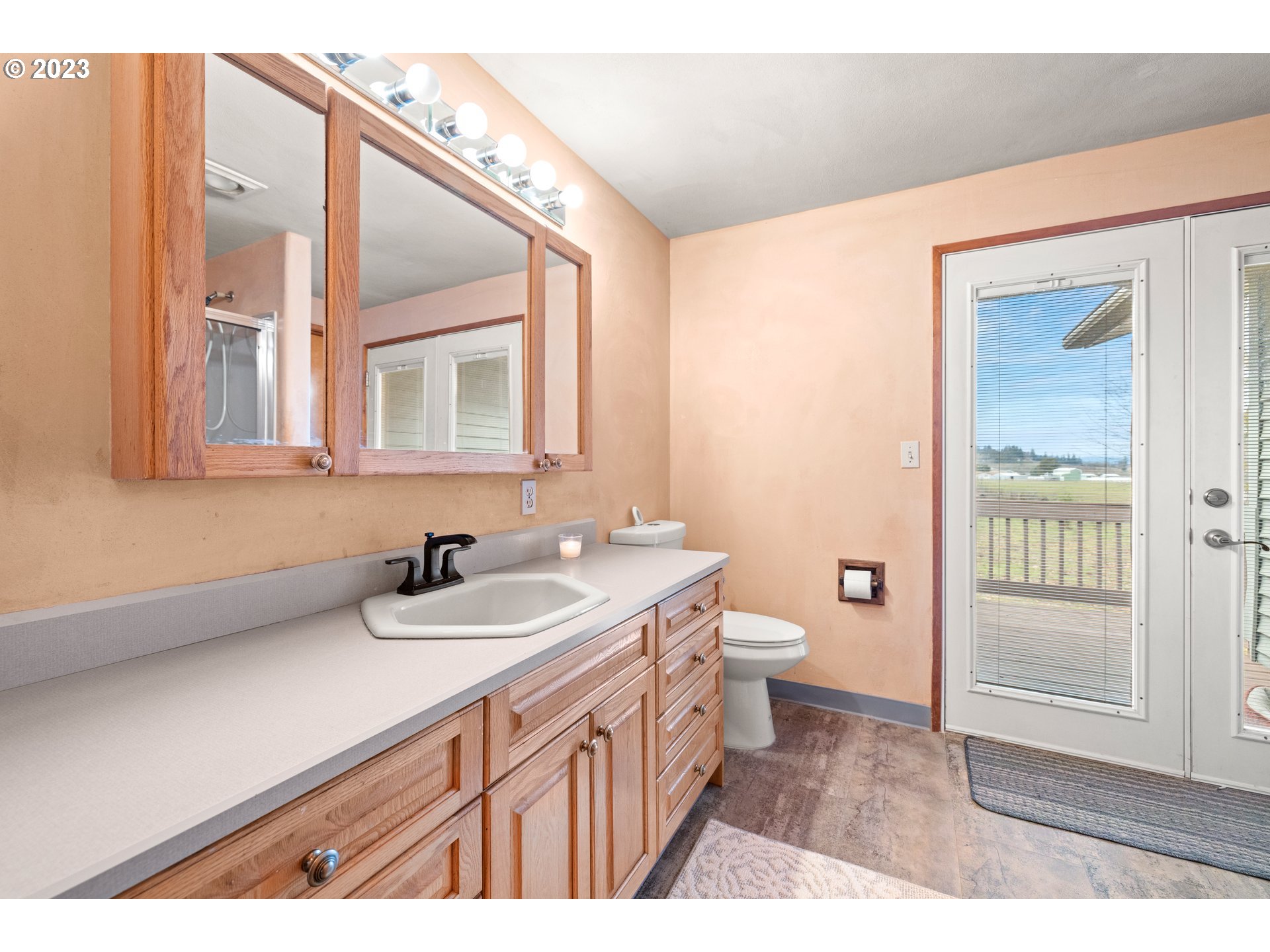 8880 Southwest River Road Hillsboro, OR 97123 - Photo 17 of 25 a bathroom with a sink a toilet and shower