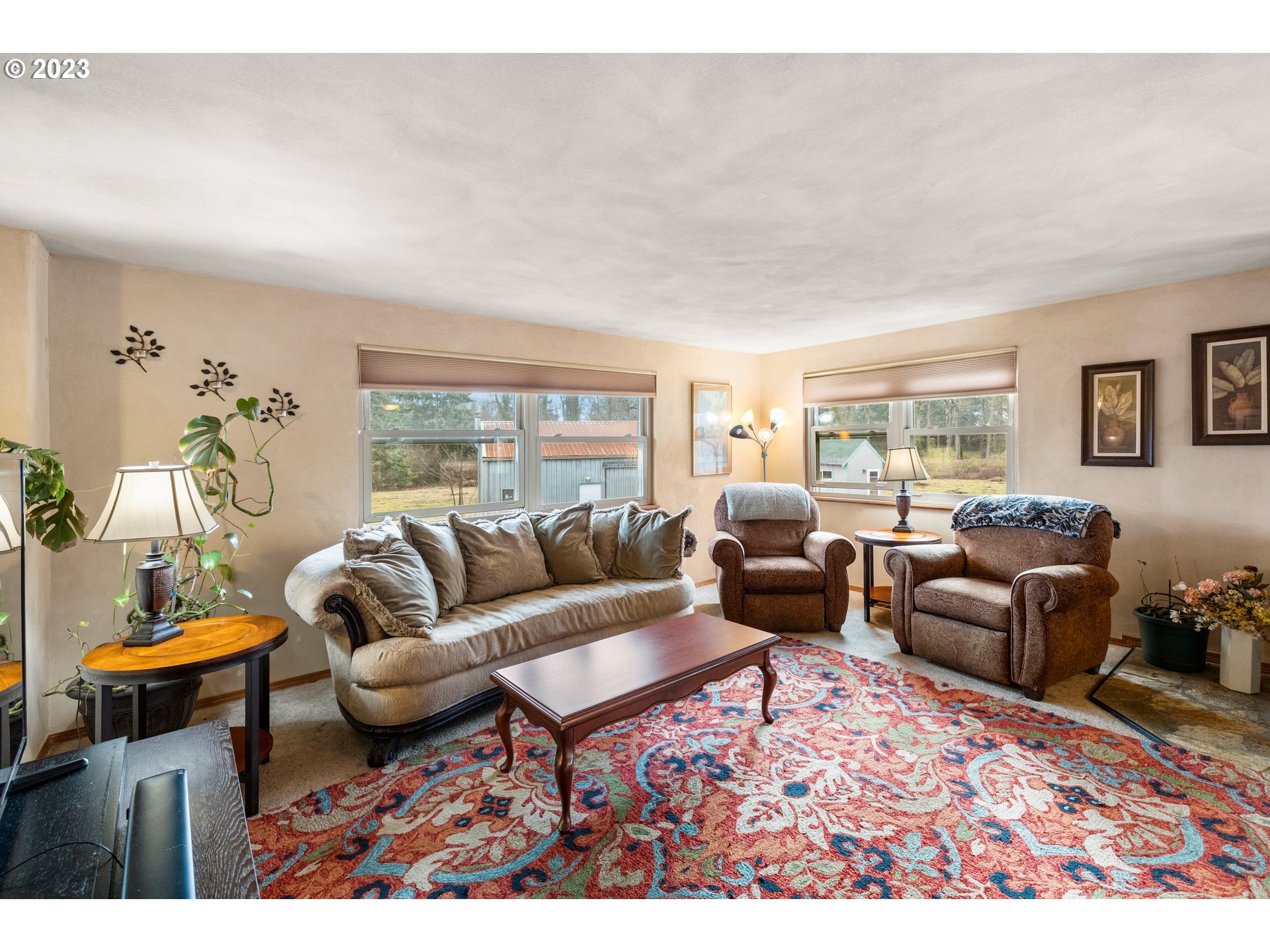 8880 Southwest River Road Hillsboro, OR 97123 - Photo 3 of 25 a living room with furniture a rug and a large window