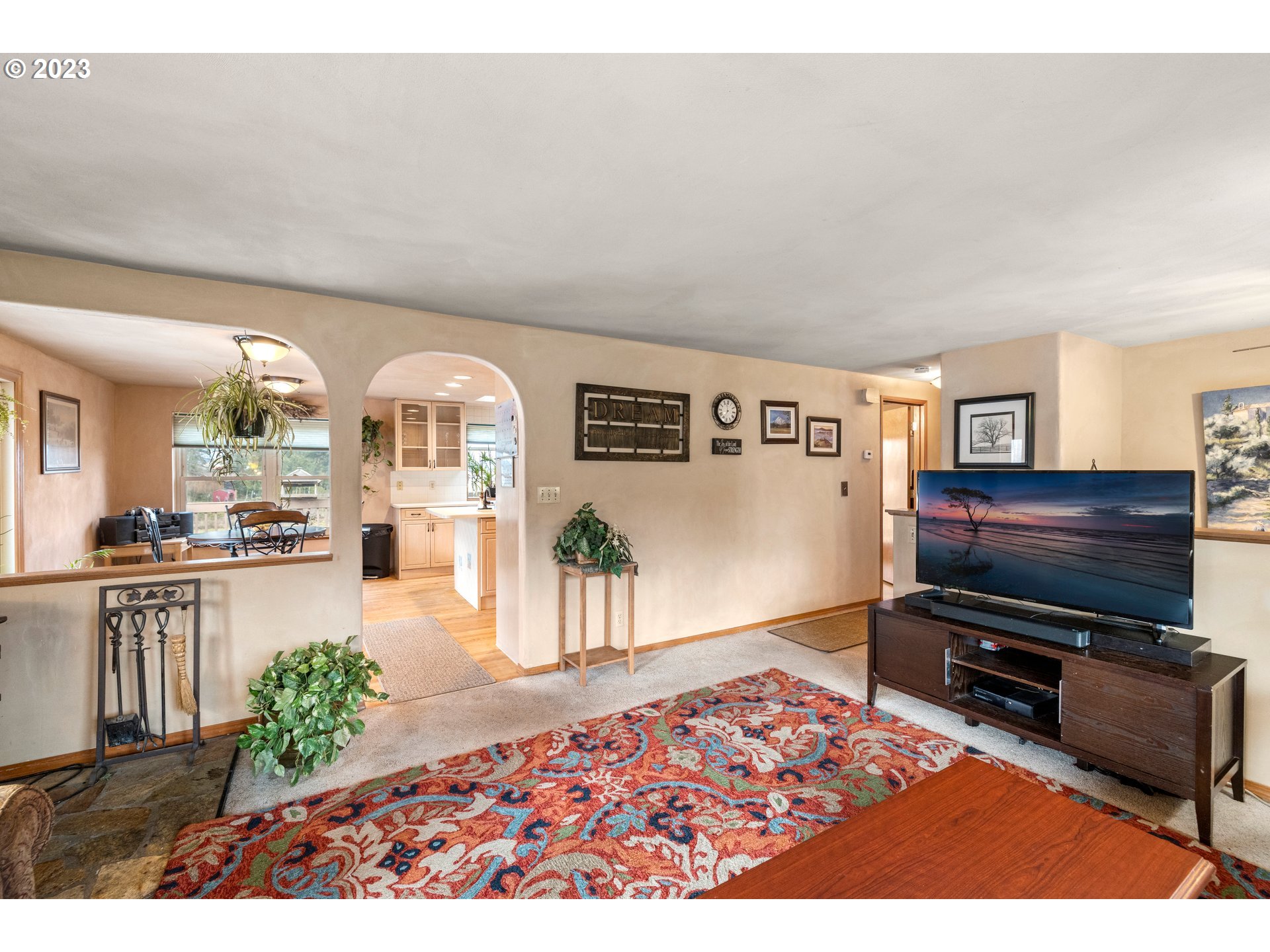 8880 Southwest River Road Hillsboro, OR 97123 - Photo 5 of 25 a living room with furniture and a flat screen tv