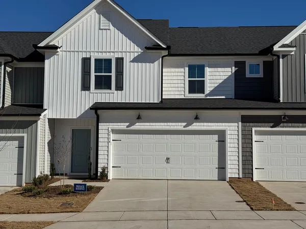 a front view of a house with garage