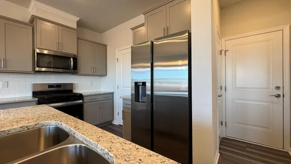a kitchen with a refrigerator and a sink