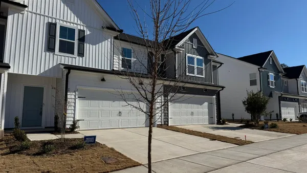 a front view of a house with yard