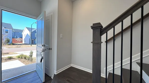 a view of an entryway with wooden floor and door